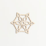 A snowflake shaped Japanese Shina wood laser cut Christmas decoration, made by Sukima and available at NiMi Projects UK