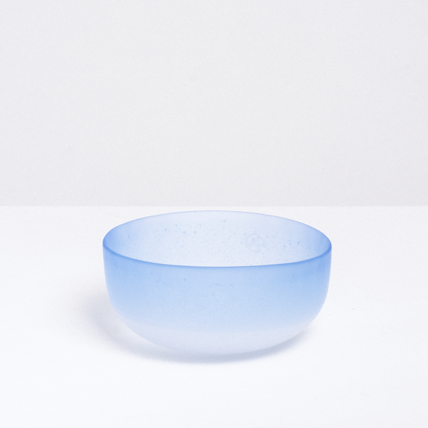 Side view of a vintage small round Japanese glass bowl in frosted blue.