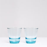 A pair of blue Spash stackable glass tumblers, made in Japan by Toyo Sasaki Glass and available at NiMi Projects UK.