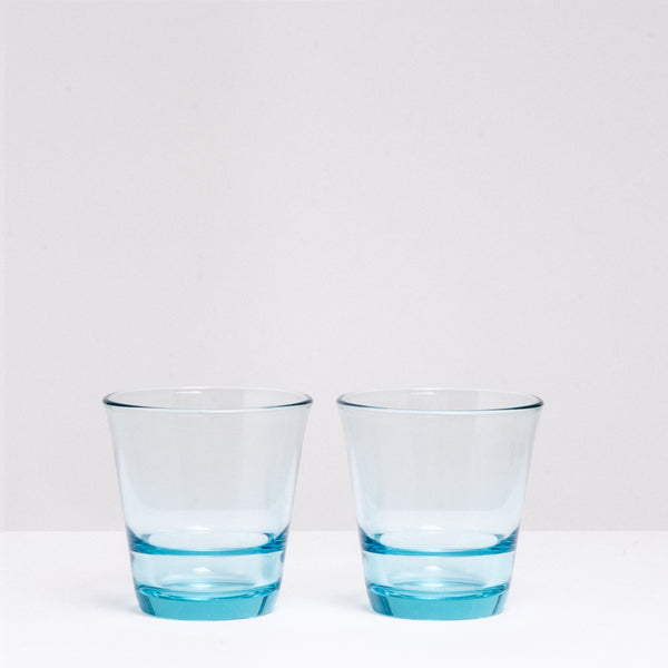 A pair of blue Spash stackable glass tumblers, made in Japan by Toyo Sasaki Glass and available at NiMi Projects UK.