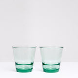 A pair of green Japanese glass Spash, stackable tumblers, made by Toyo Sasaki Glass and available at NiMi Projects UK.